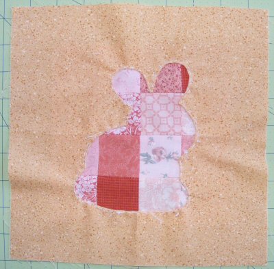 Baste the patchwork blocks behind the background fabrics